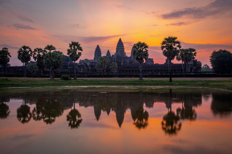 A breathtaking sunrise over the iconic Angkor Wat temple complex in Cambodia, reflected in a still pond — highlighting Cambodia as one of the top countries to visit visa-free from India.