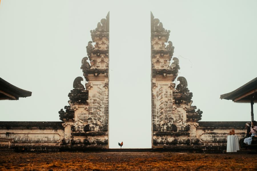 The iconic 'Gates of Heaven' at Lempuyang Temple in Bali, showcasing a majestic split gate against a bright sky, a popular landmark among temples to visit in Bali.