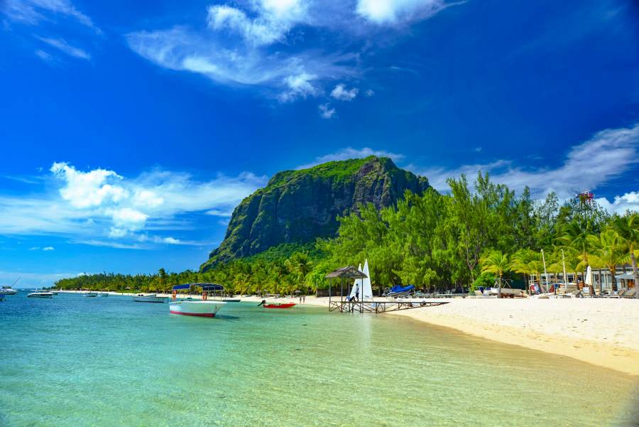 A stunning beach scene in Mauritius with turquoise waters, white sand, and the majestic Le Morne Brabant mountain in the background — showcasing Mauritius as one of the top countries to visit visa-free from India.