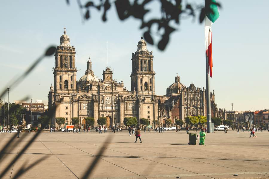 The Metropolitan Cathedral in Mexico City on a sunny day, with people walking across the plaza—showcasing Mexico as one of the best countries to visit in December for cultural experiences and warm weather.