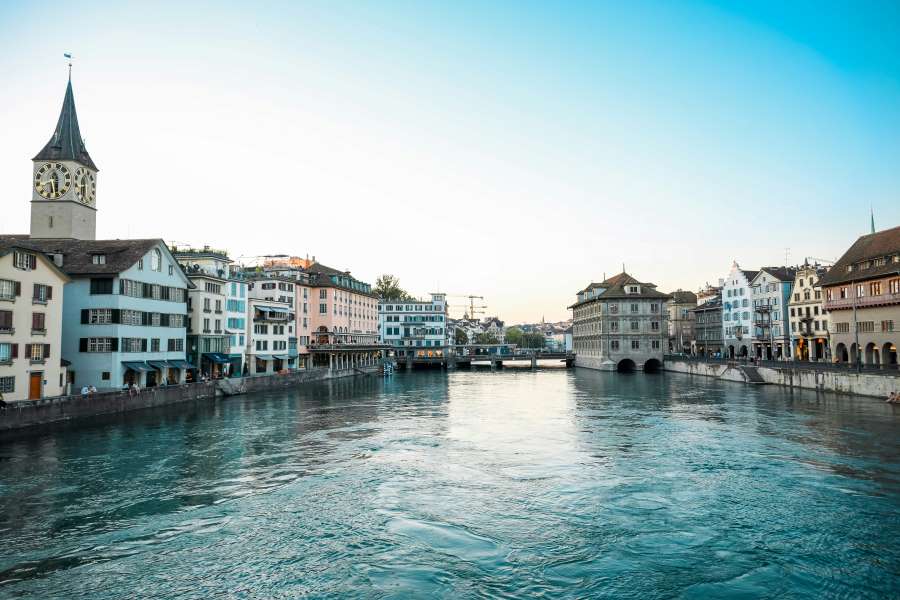 Scenic view of Zurich, Switzerland with historic buildings along the river at sunset—showcasing why Switzerland is one of the best countries to visit in December.