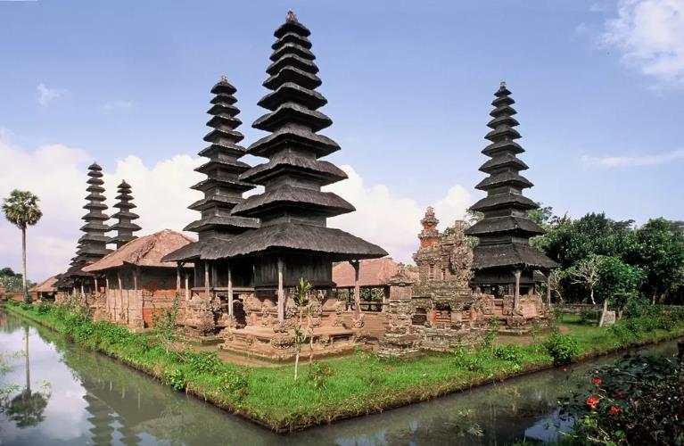 The majestic multi-tiered shrines (meru) of Taman Ayun Temple under a vibrant blue sky, showcasing the beautiful architecture of temples to visit in Bali.