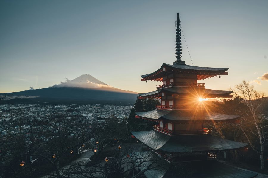Chureito Pagoda with the sun setting behind it and Mount Fuji in the background, Japan.